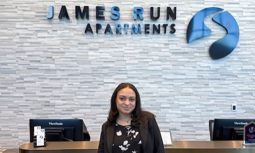 a woman standing in front of a desk