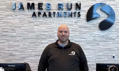a man standing in front of a desk