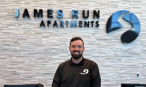 a man standing in front of a desk