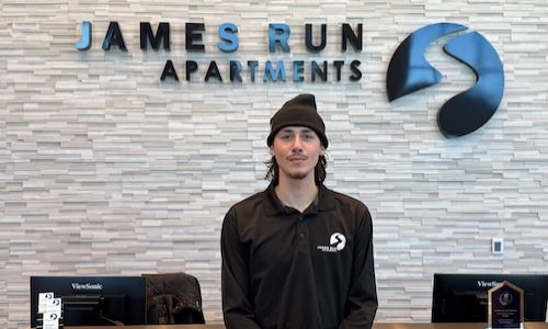 a man standing in front of a desk