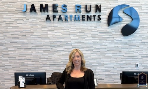 a woman standing in front of a desk