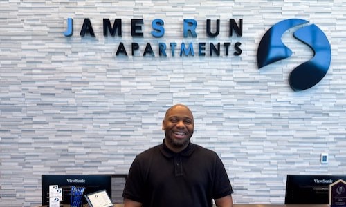 a man standing in front of a desk