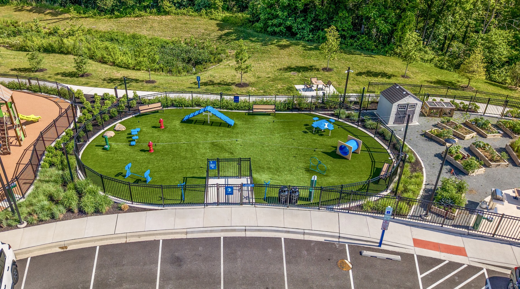 An aerial view of a dog park, playground, and garden
