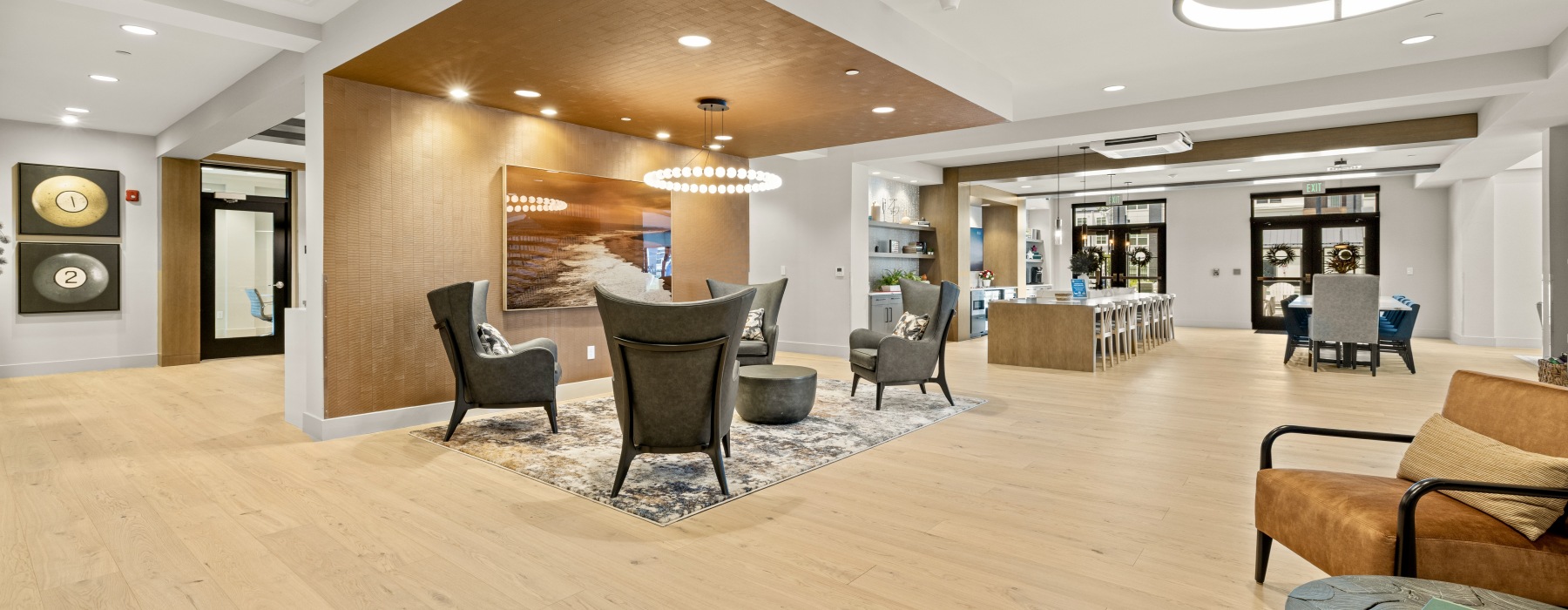 A modern clubhouse with ample seating and a kitchen