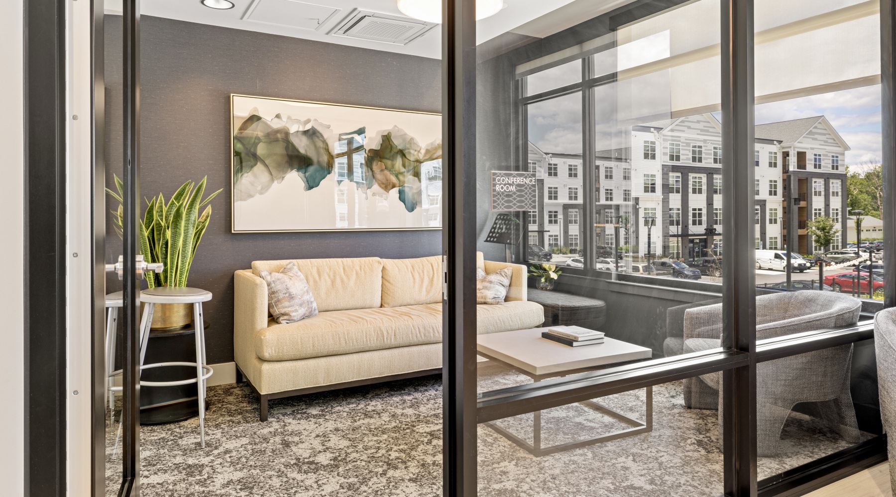 a modern conference room with a couch overlooking james run apartments