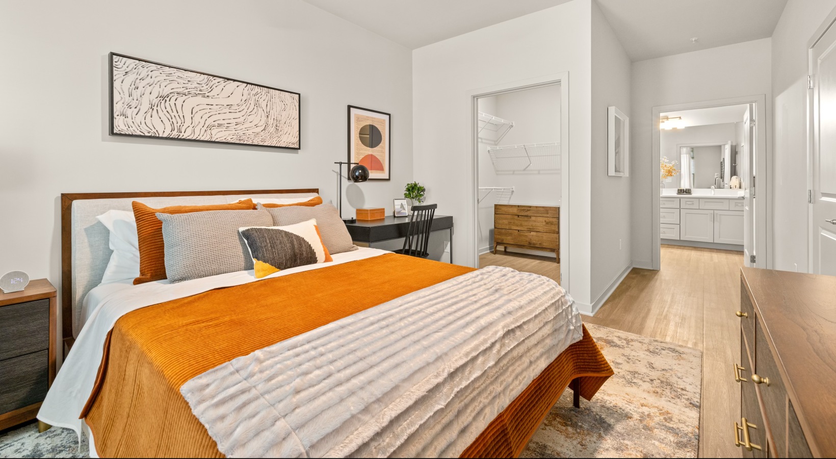 A bedroom with walk-in closet and ensuite bathroom